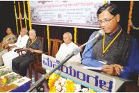 Prof. C. Naganna is seen addressing as sculptor L.Shivalingappa, Prof. AVN and others look on. 