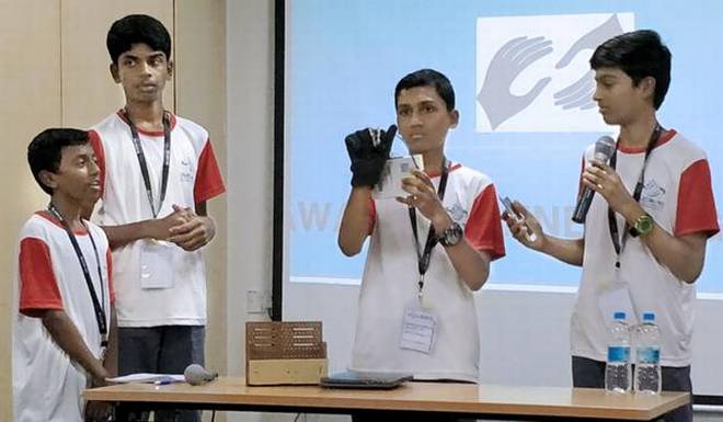 Class IX students of Kendriya Vidyalaya in Mysuru demonstrating their solution to convert sign language into audio output at the hackathon in the city on Sunday. 